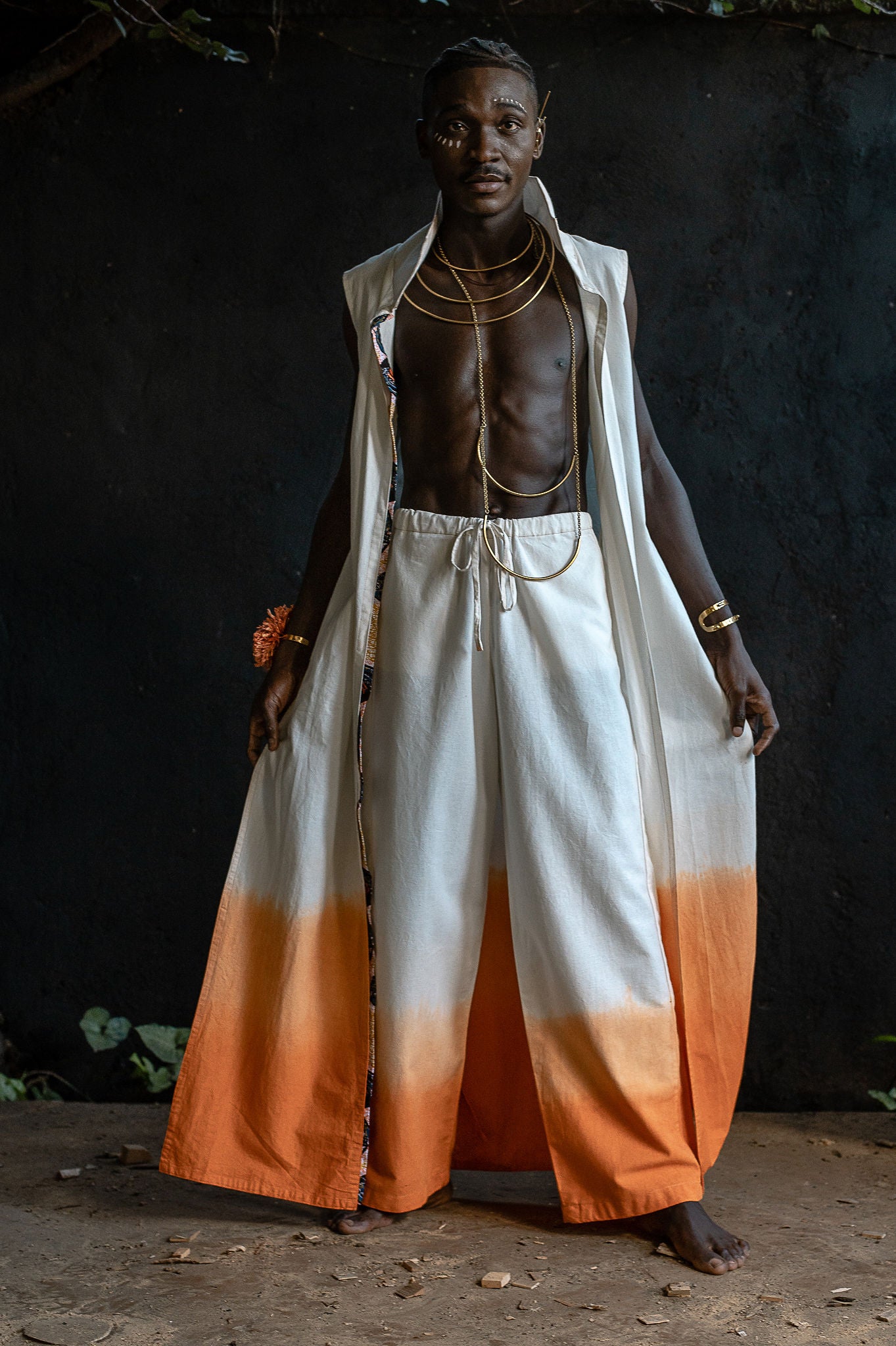 Close-up of a hand-dyed ombré hem from the UHAI collection, showing the fade from cream to orange